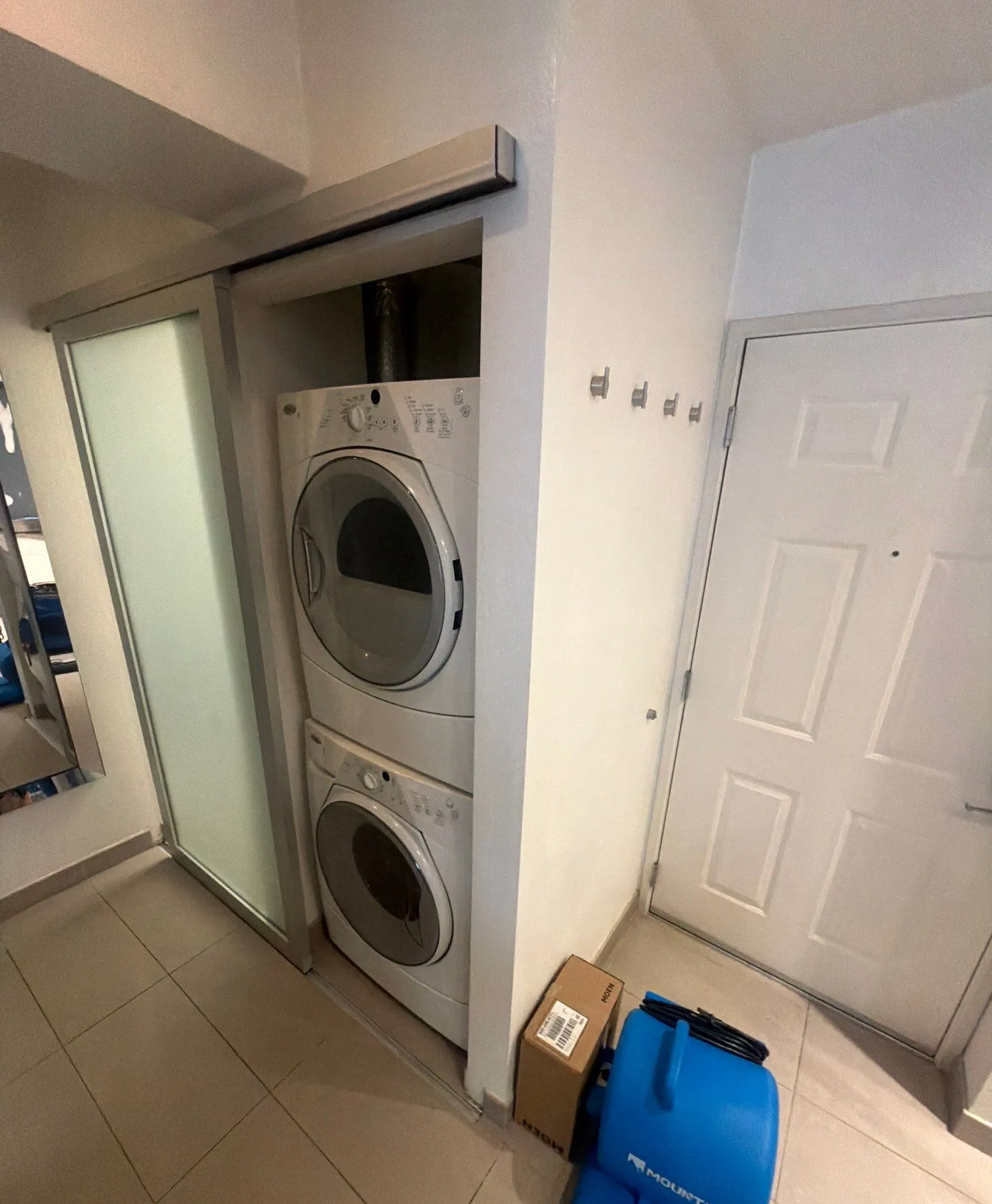 Washer and dryer alcove in a University City condo with a drying fan